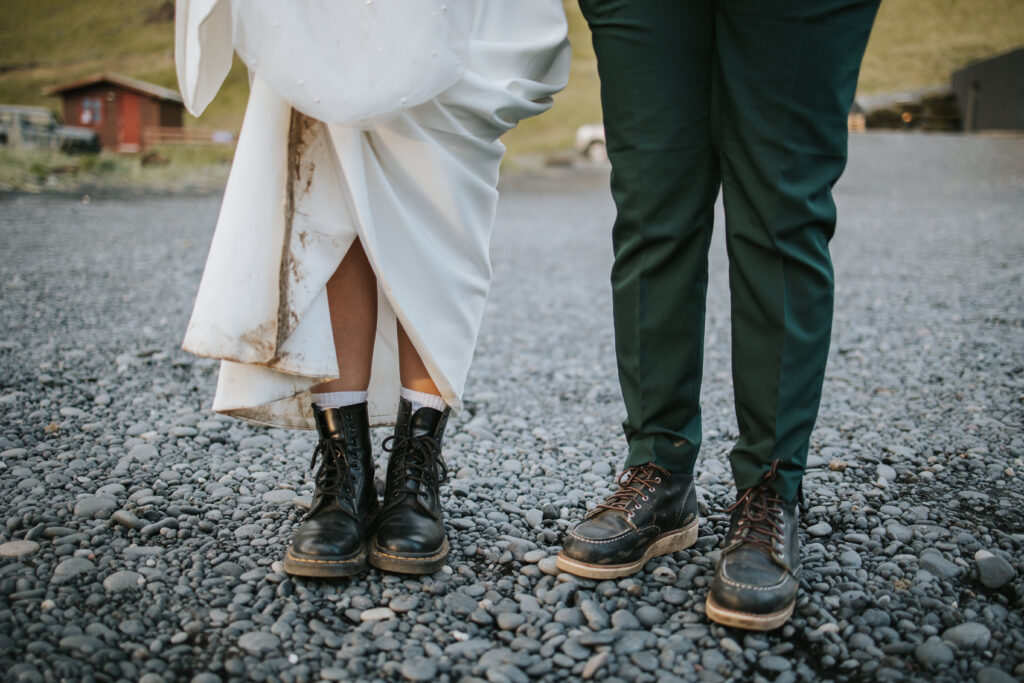 Detail photo of a dirty dress and hiking boots for the couple on their Icelandic elopement day.