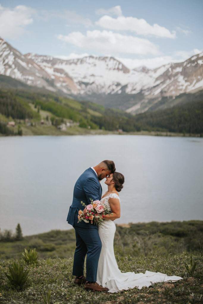 Couple resting their foreheads together on their Colorado elopement wedding day.