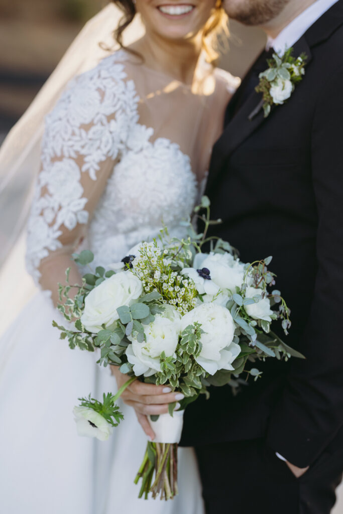 Bride and groom holding hands under a canopy at an Atlanta wedding venue.