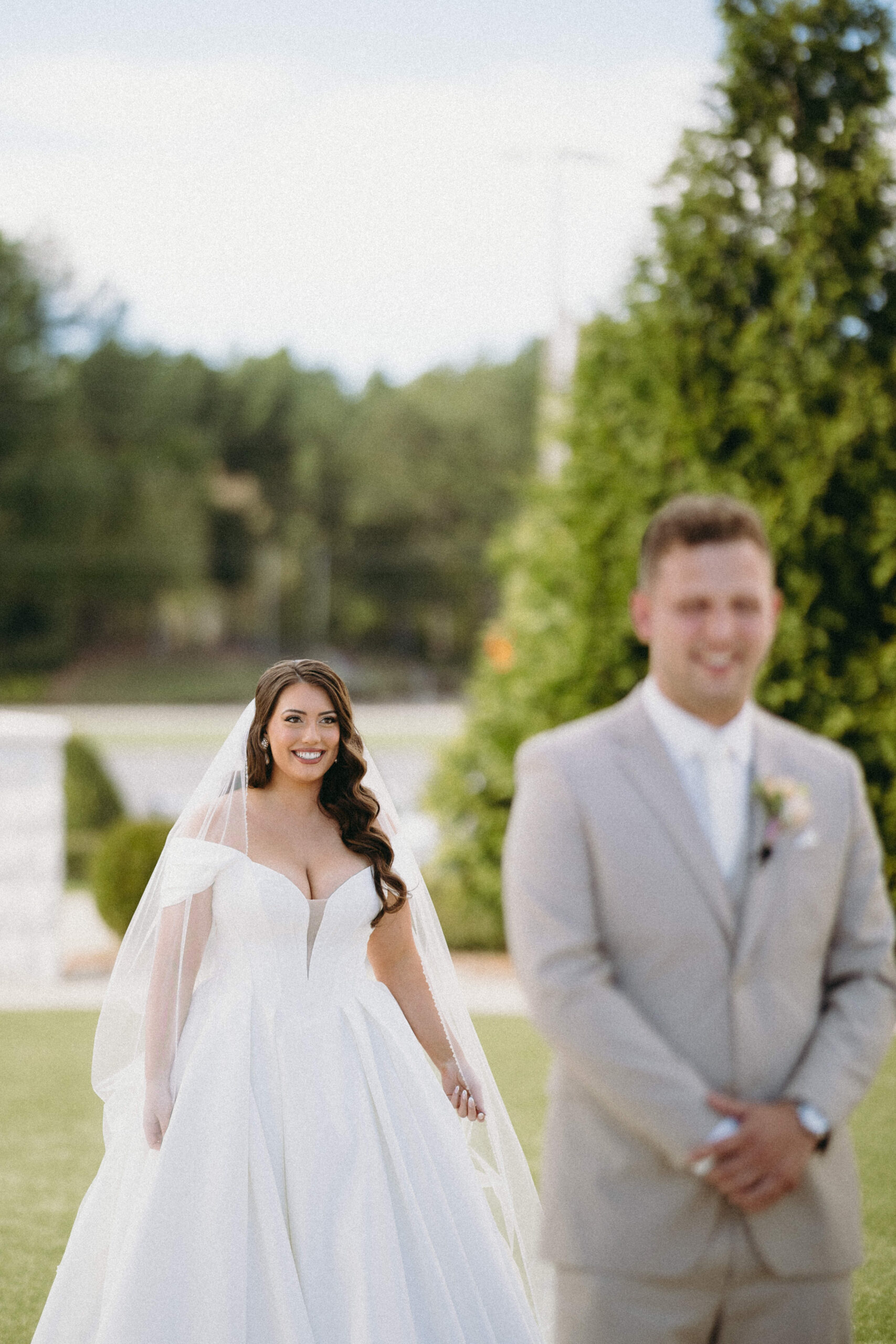 Bride walking down the aisle in a stunning wedding gown, captured in timeless black and white photography.