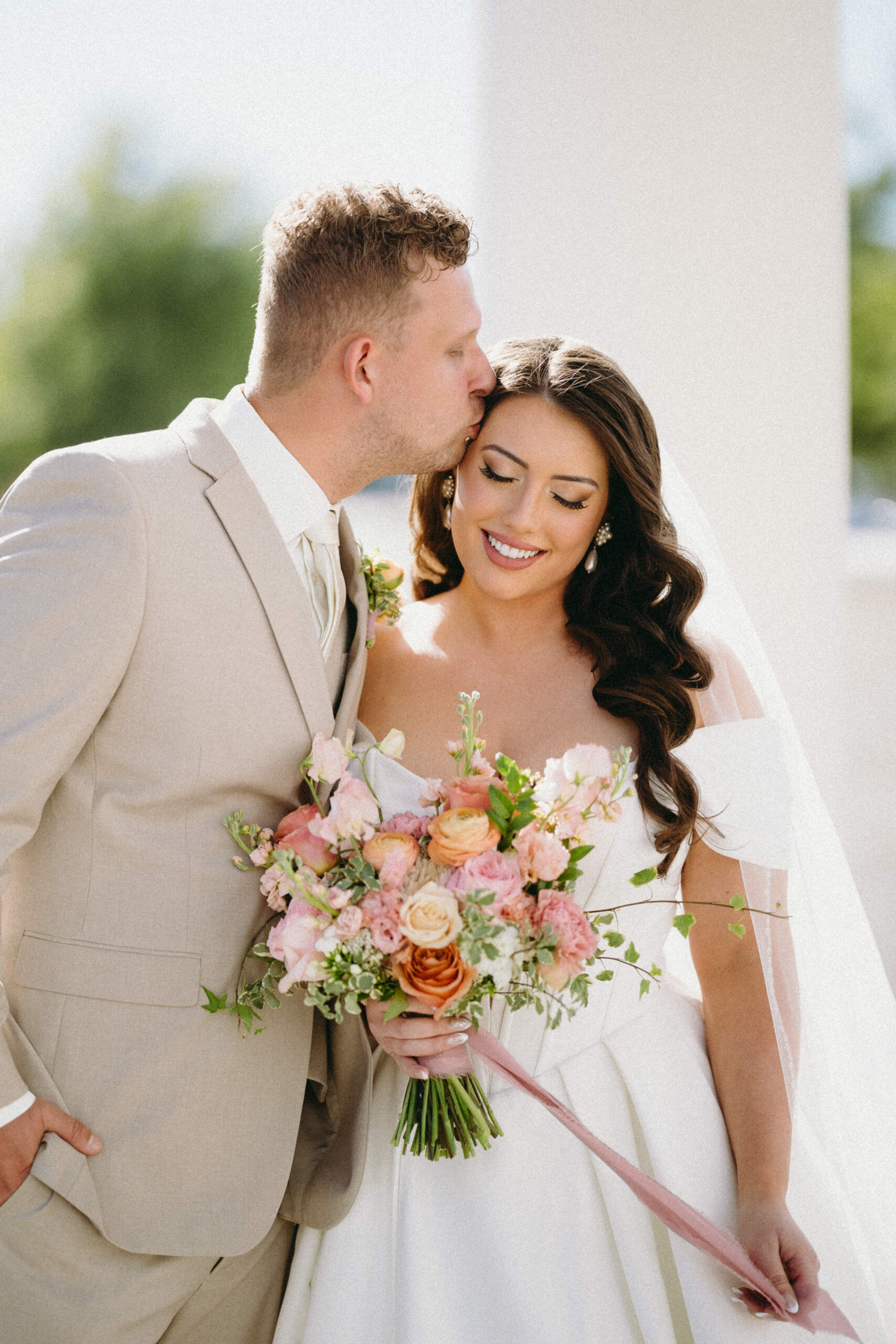 Romantic sunset wedding photo of the couple embracing on a Georgia estate photographed by their luxury wedding photographer.