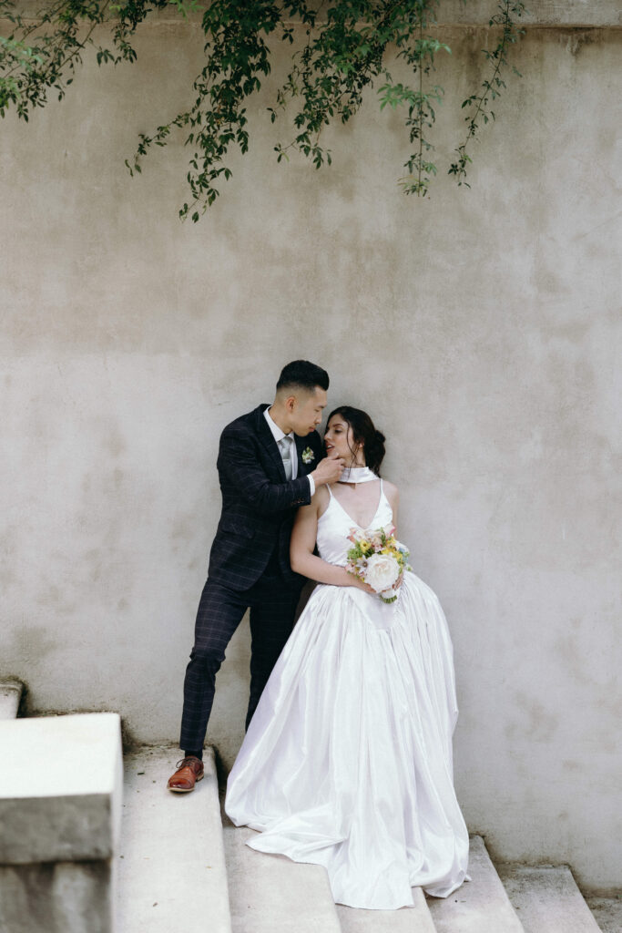 Newlyweds share a kiss at an iconic Atlanta wedding venue.
